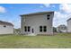 Backyard view of a two-story home with a spacious lawn at 16 Camellia Dr, Fairburn, GA 30213