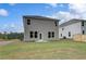 Backyard view of a two-story home with a spacious lawn at 16 Camellia Dr, Fairburn, GA 30213
