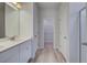Bathroom with double vanity, white cabinets, walk-in closet, and walk-in shower at 16 Camellia Dr, Fairburn, GA 30213