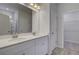 Bathroom featuring a double vanity with white cabinets, walk-in closet, and walk-in shower at 16 Camellia Dr, Fairburn, GA 30213