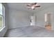 Large bedroom with neutral carpet, a ceiling fan, and doorways to other rooms at 16 Camellia Dr, Fairburn, GA 30213