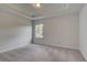 Well-lit bedroom features neutral carpet and tray ceiling at 16 Camellia Dr, Fairburn, GA 30213