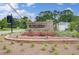 Community entrance sign with lush landscaping at 16 Camellia Dr, Fairburn, GA 30213