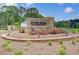 Community entrance sign with lush landscaping at 16 Camellia Dr, Fairburn, GA 30213
