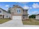 Beautiful two-story home with a well-manicured lawn and a two-car garage at 16 Camellia Dr, Fairburn, GA 30213