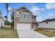 Modern two-story home showcasing a brick and siding design with an attached two-car garage at 16 Camellia Dr, Fairburn, GA 30213