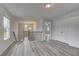 Bright hallway with modern flooring, stairs, and views into other rooms at 16 Camellia Dr, Fairburn, GA 30213