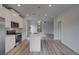 Contemporary kitchen with stainless steel appliances, island with sink, quartz countertops, and hardwood floors at 16 Camellia Dr, Fairburn, GA 30213