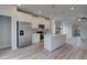Modern kitchen with stainless steel appliances, white cabinets, quartz countertops, and hardwood floors at 16 Camellia Dr, Fairburn, GA 30213
