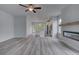 Spacious living room with wood-look floors, a ceiling fan, and a modern fireplace feature at 16 Camellia Dr, Fairburn, GA 30213