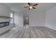 Open living area with wood-look floors, a modern fireplace, and abundant natural light at 16 Camellia Dr, Fairburn, GA 30213