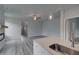 Open-concept living room with hardwood floors, a modern fireplace, and plenty of natural light at 16 Camellia Dr, Fairburn, GA 30213