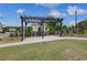 Outdoor pergola with seating, landscaped surroundings and walkway at 16 Camellia Dr, Fairburn, GA 30213