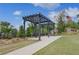 Outdoor pergola with seating, landscaped surroundings and walkway at 16 Camellia Dr, Fairburn, GA 30213