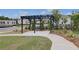 Outdoor pergola with seating, landscaped surroundings and walkway at 16 Camellia Dr, Fairburn, GA 30213