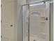 Modern shower with sliding glass doors and built-in shelving at 16 Camellia Dr, Fairburn, GA 30213