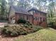 Two-story brick home with attached garage and landscaping at 1461 Fox Forest Sw Ter, Lilburn, GA 30047