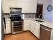 Modern kitchen featuring stainless steel appliances and white cabinets at 1461 Fox Forest Sw Ter, Lilburn, GA 30047