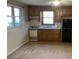 Efficient kitchen featuring wood cabinets, stove, refrigerator, and window at 1461 Fox Forest Sw Ter, Lilburn, GA 30047