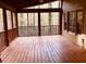 Screened porch with wooden deck and view of wooded area at 1461 Fox Forest Sw Ter, Lilburn, GA 30047