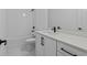 Modern bathroom with white marble floors, white cabinets, and modern fixtures at 231 Strawberry Ln, Woodstock, GA 30189