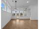 Bright dining room with hardwood floors and plenty of natural light from windows and a glass door at 231 Strawberry Ln, Woodstock, GA 30189