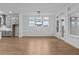 Dining area featuring hardwood floors, large windows and an elegant modern chandelier at 231 Strawberry Ln, Woodstock, GA 30189