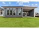 Back of the house with gray siding, covered patio, and spacious green yard at 231 Strawberry Ln, Woodstock, GA 30189