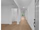 Bright hallway with white trim, and wood floors leading to sunlit living spaces, offers a modern, clean aesthetic at 231 Strawberry Ln, Woodstock, GA 30189