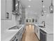 Well-lit kitchen featuring stainless steel appliances, gas cooktop, gray cabinets, quartz countertops, and hardwood floors at 231 Strawberry Ln, Woodstock, GA 30189