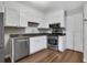 Kitchen with white cabinets, granite countertops, and stainless steel appliances at 11 Newport Nw Pl, Atlanta, GA 30318