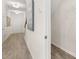 Bright hallway with wood-look flooring, coat closet, and access to staircase at 2720 Ravencliff Dr, Austell, GA 30168