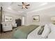 Main bedroom with ceiling fan and sitting area at 2720 Ravencliff Dr, Austell, GA 30168