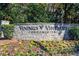 Vinings Vineyard Condominiums stone entrance sign surrounded by colorful flowers and greenery at 4100 Paces Se Walk # 1306, Atlanta, GA 30339