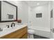 Updated bathroom with modern fixtures, a wood vanity, and a tiled shower over tub at 2349 Springdale Sw Rd, Atlanta, GA 30315