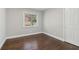Bright bedroom featuring hardwood floors, fresh paint, closet, and a window with a view at 2349 Springdale Sw Rd, Atlanta, GA 30315