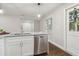 Renovated kitchen features a granite countertop and stainless steel dishwasher at 2349 Springdale Sw Rd, Atlanta, GA 30315