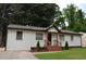 Charming one-story home featuring painted brick, a welcoming front porch, and manicured landscaping at 2349 Springdale Sw Rd, Atlanta, GA 30315