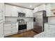 Modern kitchen features stainless appliances, white cabinets, granite counters and subway tile backsplash at 2349 Springdale Sw Rd, Atlanta, GA 30315