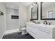 Modern bathroom featuring double vanity sinks and sleek, glass enclosed shower with built-in niche at 2349 Springdale Sw Rd, Atlanta, GA 30315