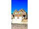 A two-story townhome with brown siding, a white garage door, and green shutters at 3102-A Brownstone Se Ln, Atlanta, GA 30354