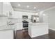 Kitchen features white cabinets, stainless steel appliances, granite counters, and subway tile backsplash at 3102-A Brownstone Se Ln, Atlanta, GA 30354