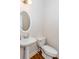 Cozy half bath featuring white fixtures and hardwood flooring at 3330 Madison St, Atlanta, GA 30337