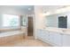 Spacious bathroom with a soaking tub, separate shower, and a large window at 3330 Madison St, Atlanta, GA 30337