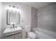 Modern bathroom with gray tile, a new vanity, and a bathtub at 6724 Oakland Dr, Douglasville, GA 30135