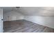 Large attic bedroom with wood-look floors and sloped ceilings at 6724 Oakland Dr, Douglasville, GA 30135