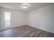 Bright bedroom with hardwood floors and a large window at 6724 Oakland Dr, Douglasville, GA 30135