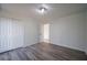 Well-lit bedroom, showcasing wood-look floors and ample closet space at 6724 Oakland Dr, Douglasville, GA 30135