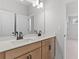 Bright bathroom featuring double sinks, modern fixtures, and a large mirror at 7675 Homer Dr, Cumming, GA 30028