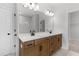 Bright bathroom featuring double sinks, modern fixtures, and a walk-in shower at 7675 Homer Dr, Cumming, GA 30028